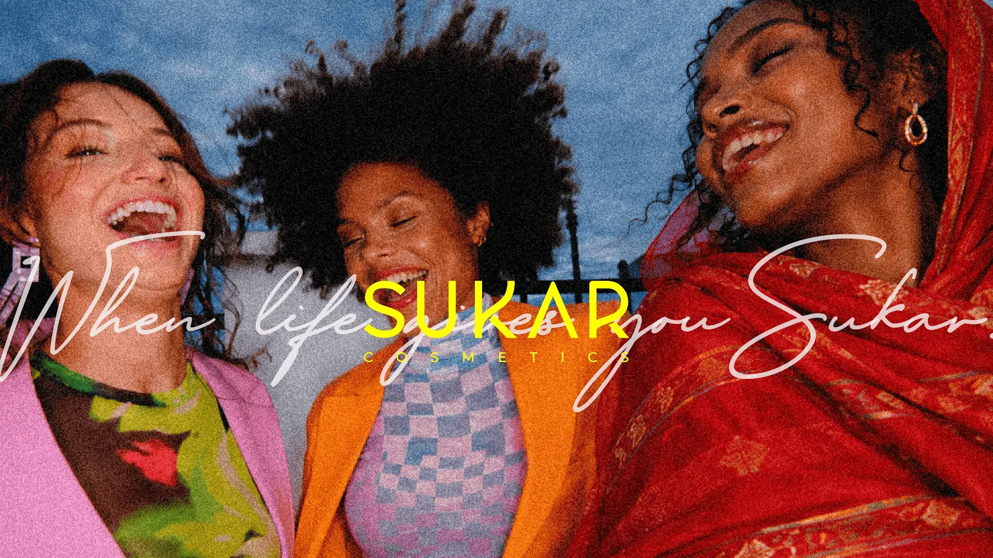 Three women laughing under the line When life gives you Sukar