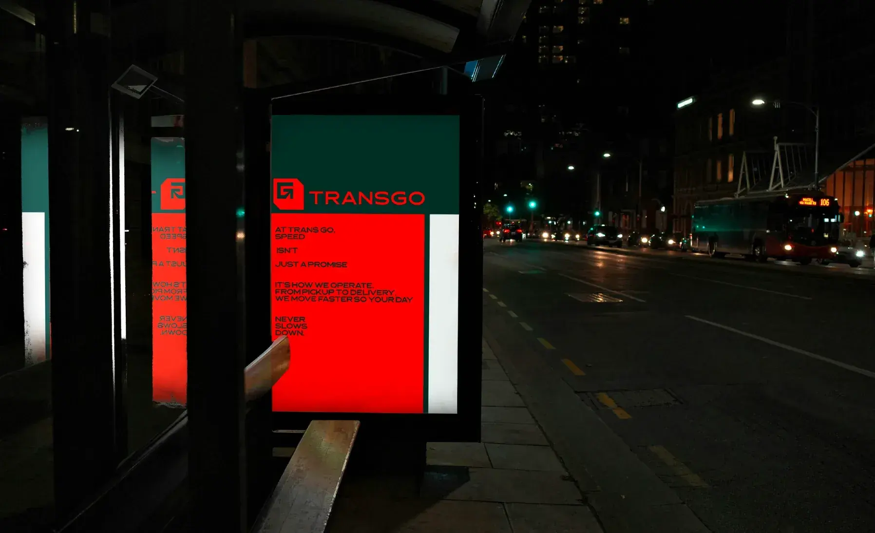 Night bus shelter with a lit advertising panel